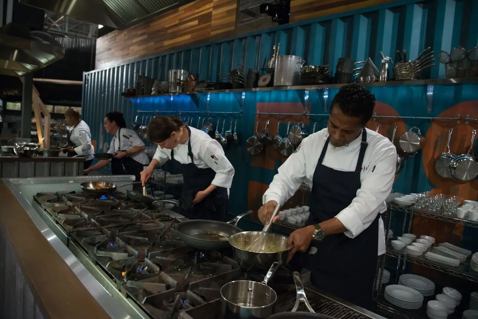 a man cooking in a kitchen preparing food