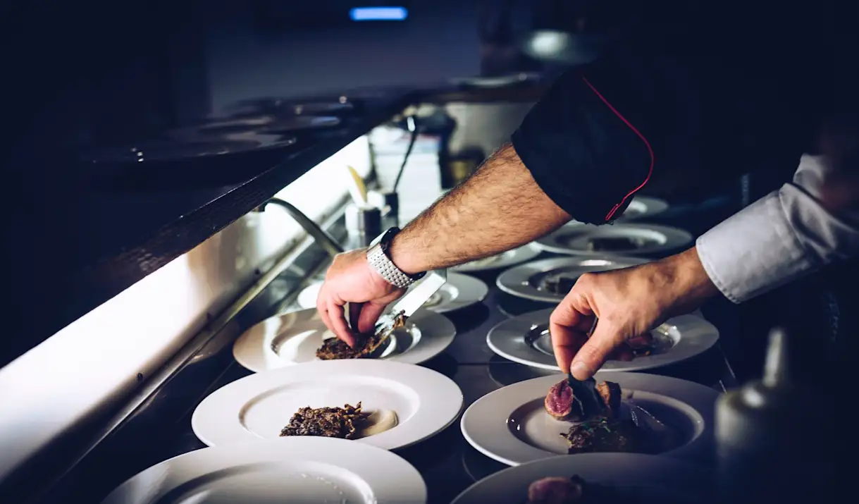 Chefs plating food for guests