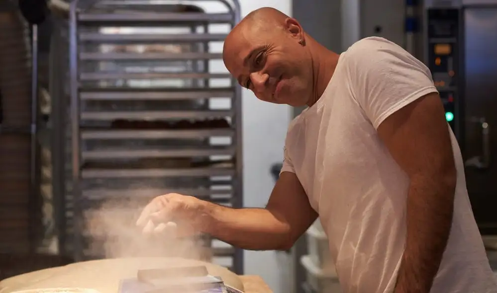 a man cooking in a kitchen preparing food