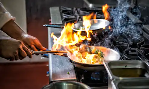 a person cooking food on a grill