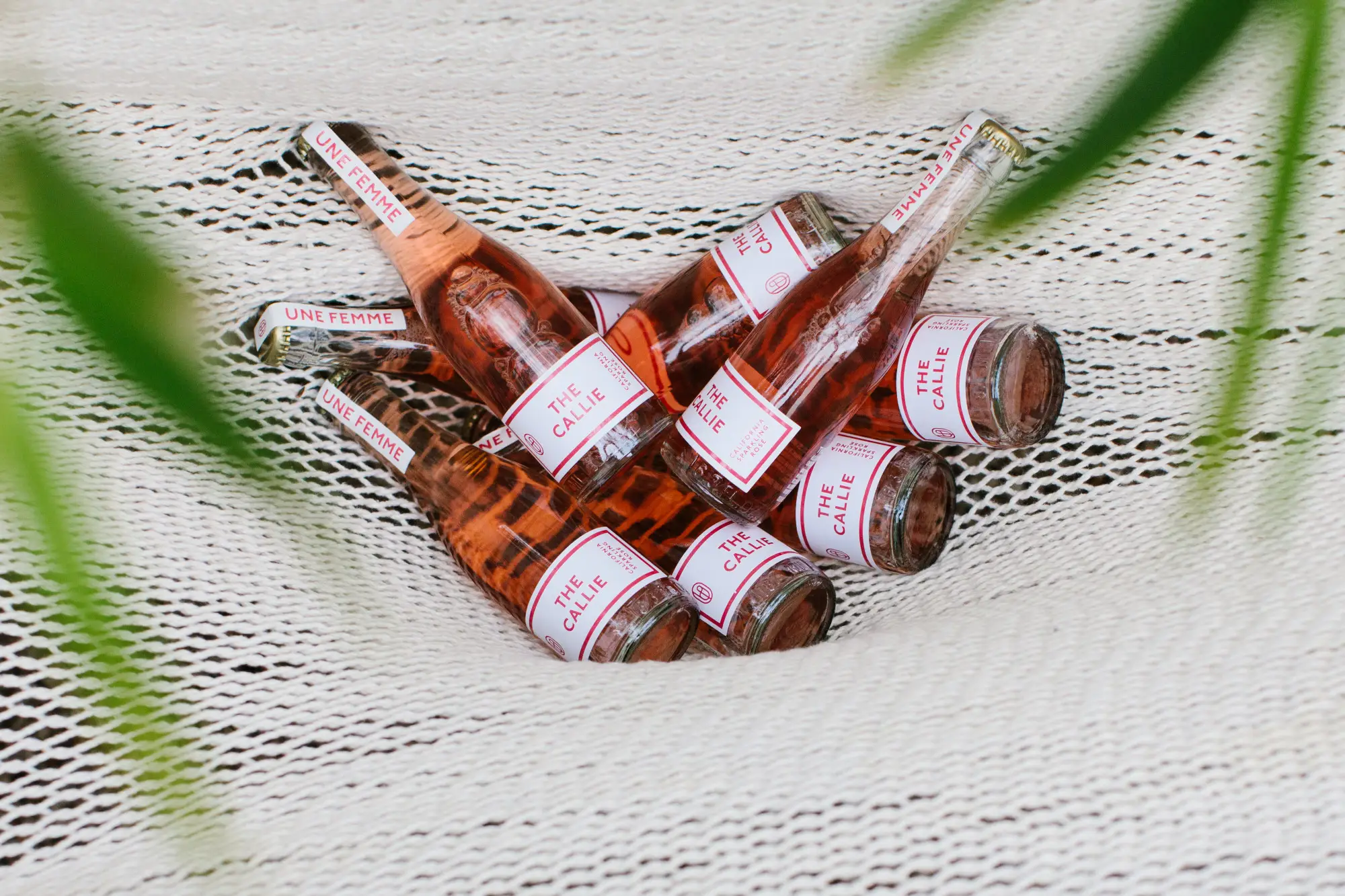 Bottles of wine in a hammock.