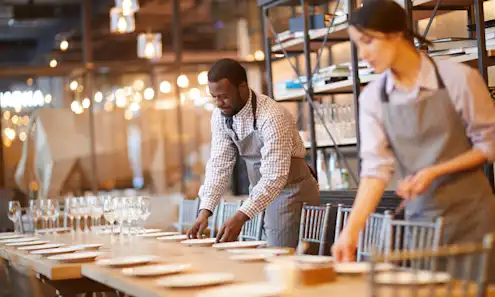 a group of people standing around a table