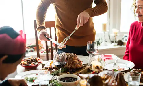 a woman cutting a cake