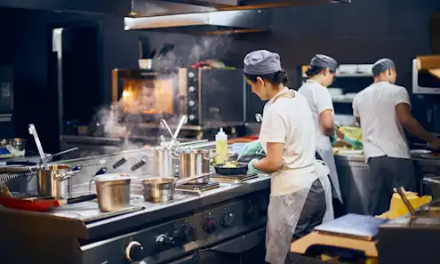 a man cooking in a kitchen preparing food