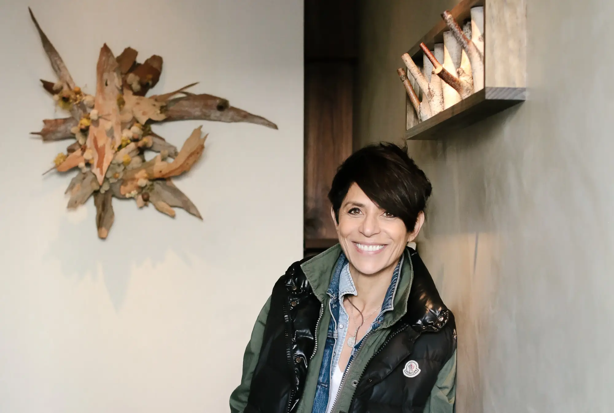 a woman leaning against a wall.