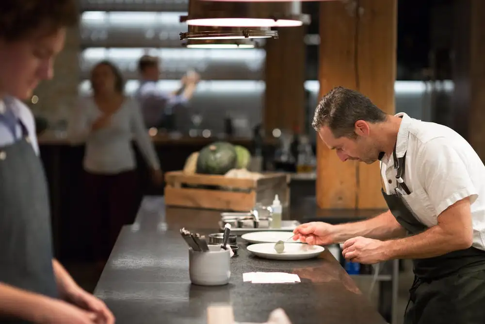 a man cooking in a kitchen preparing food