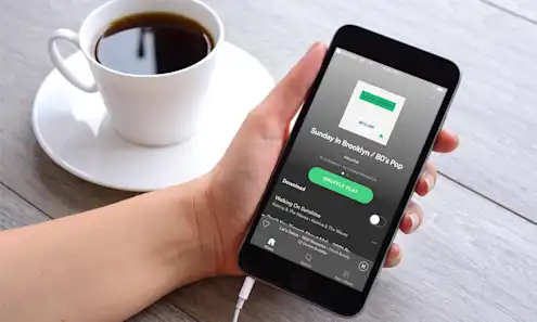 a hand holding a cup of coffee