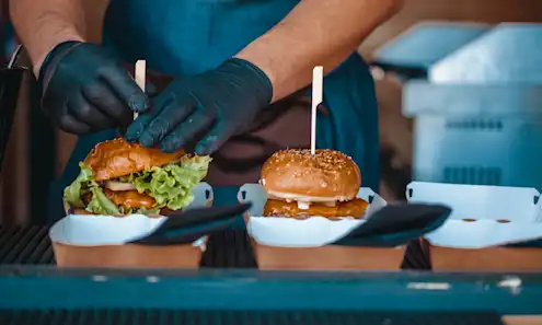 A chef plating to-go food