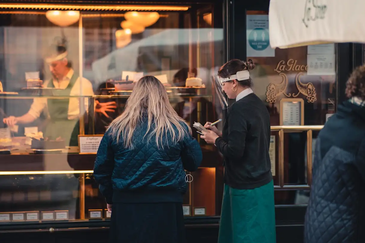 A restaurant worker wears a uniform for colder weather