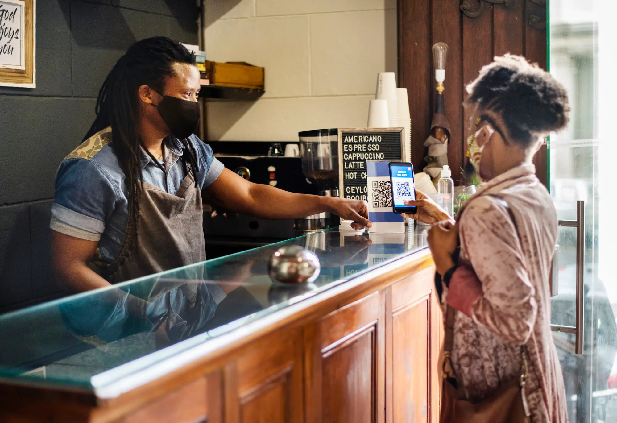 a man and woman preparing food in a kitchen