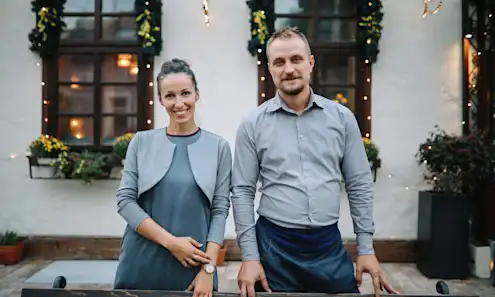 a man and a woman standing in front of a building