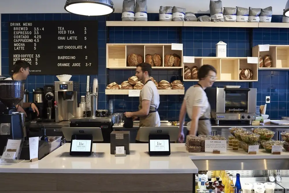 a group of people standing in front of a store