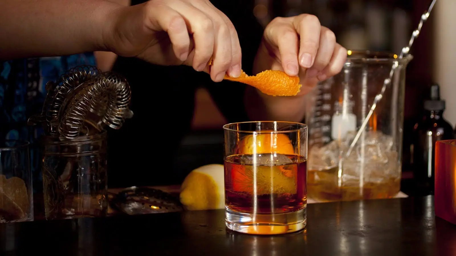 Orange peel being expressed over cocktial at Hearth