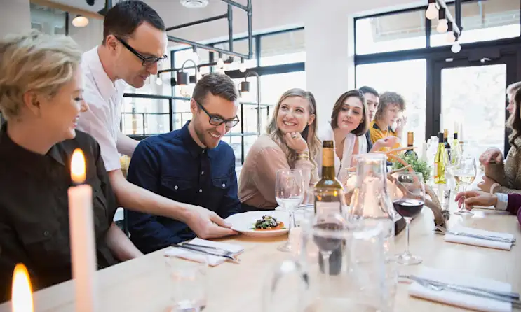 nilperi şahinkaya et al. sitting at a table with wine glasses