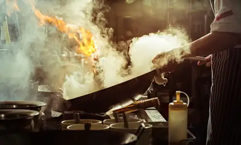 a close up of a chef cooking