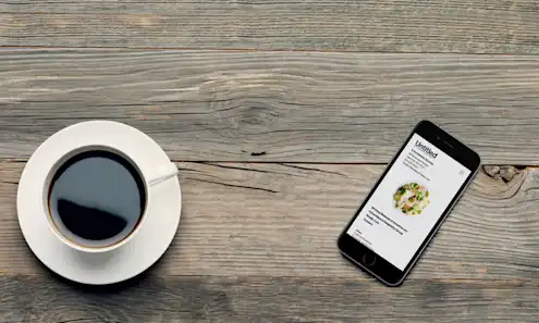 a stack of brochures on a wooden surface