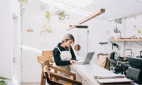 a woman sitting at a table in a room