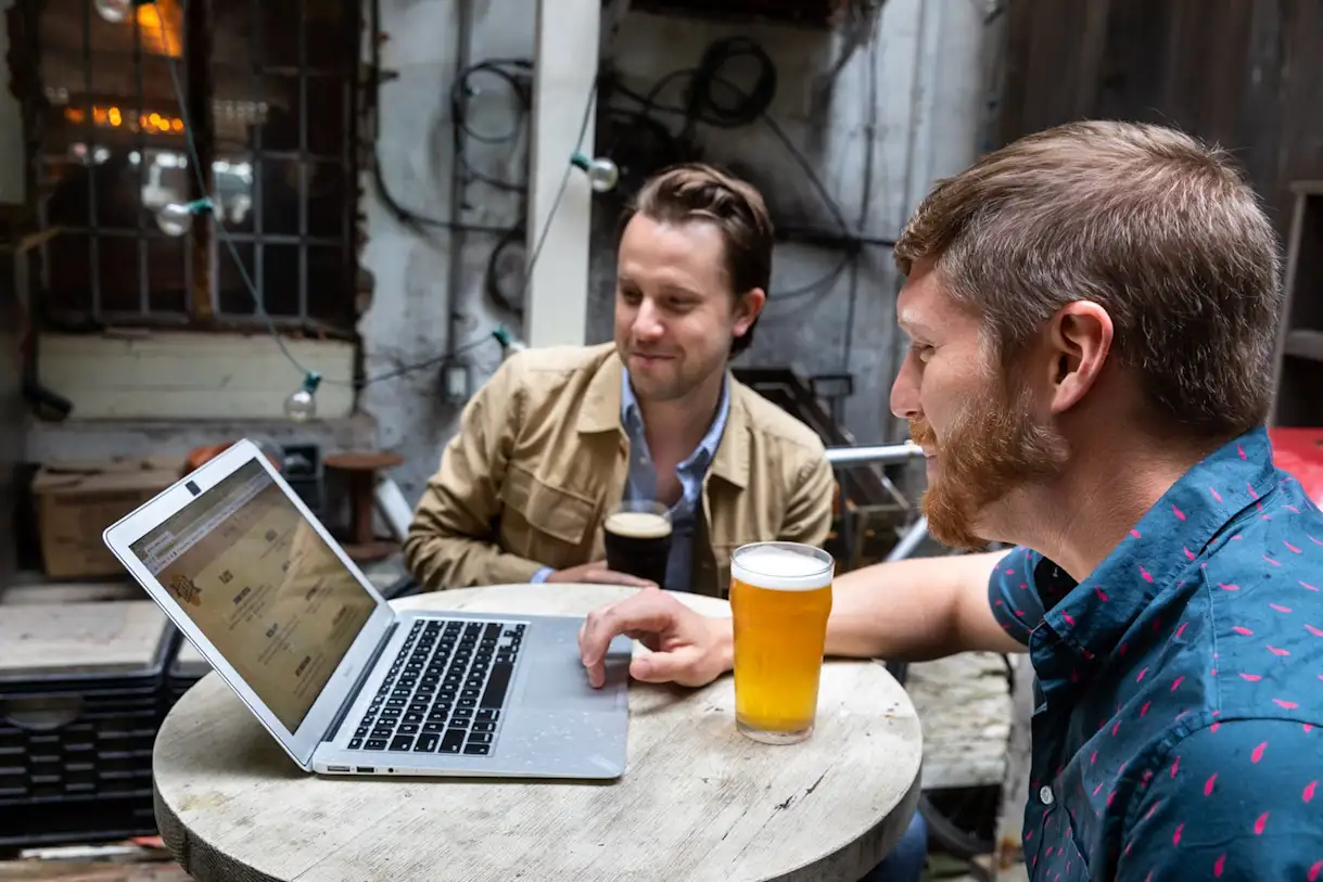 Zach Mack sitting at a table in front of a laptop