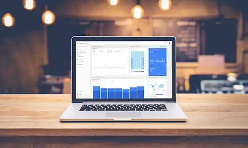 a laptop computer sitting on top of a wooden table