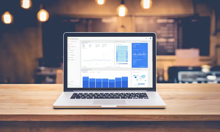 a laptop computer sitting on top of a wooden table