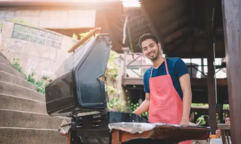 a man grilling outside