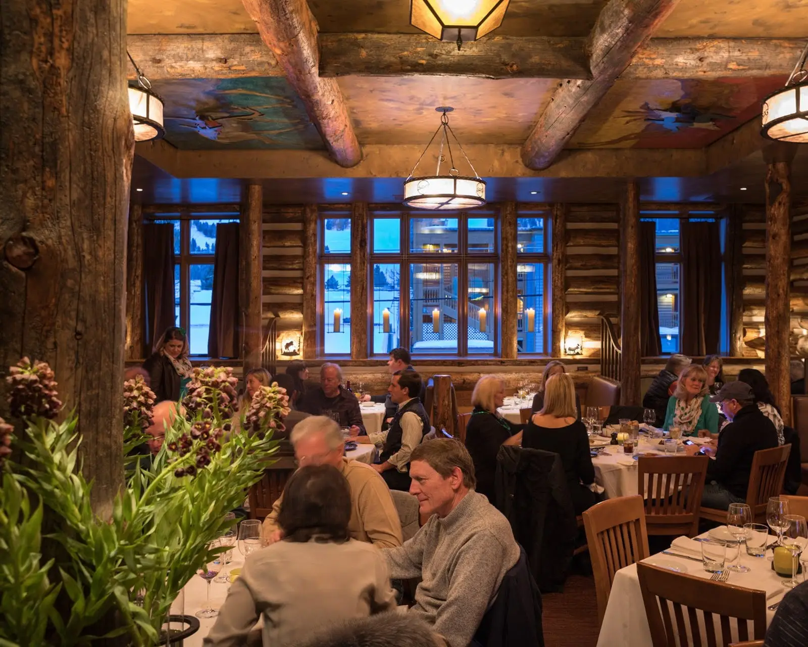 a group of people sitting at a table in a restaurant