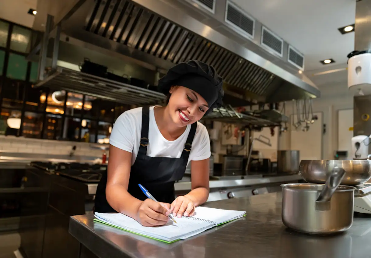 a woman preparing food in a kitchen