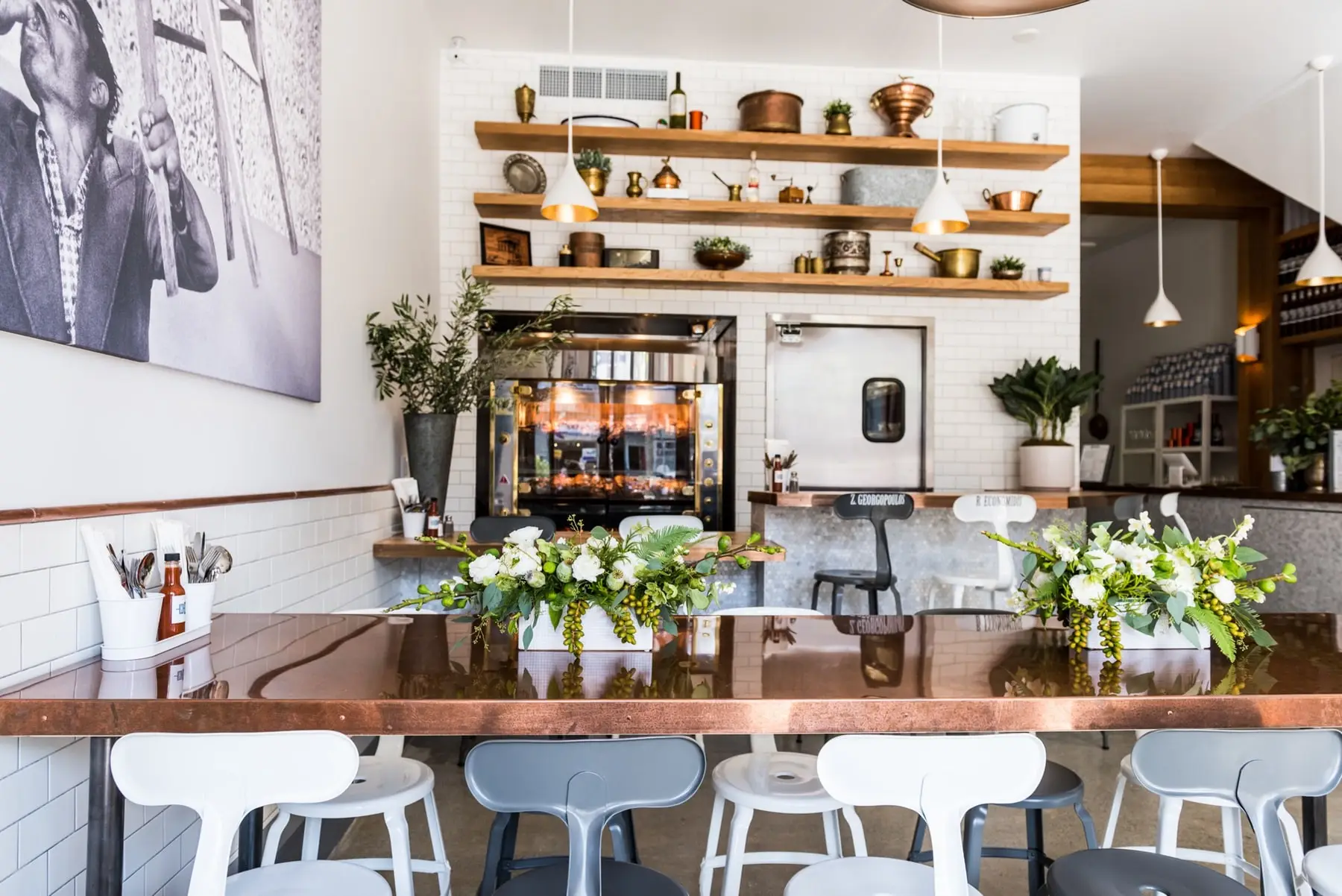 a room filled with furniture and vase of flowers on a table