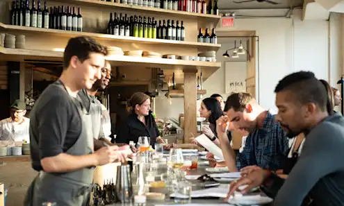 a group of people sitting at a table with wine glasses