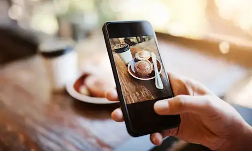 a hand holding a cell phone