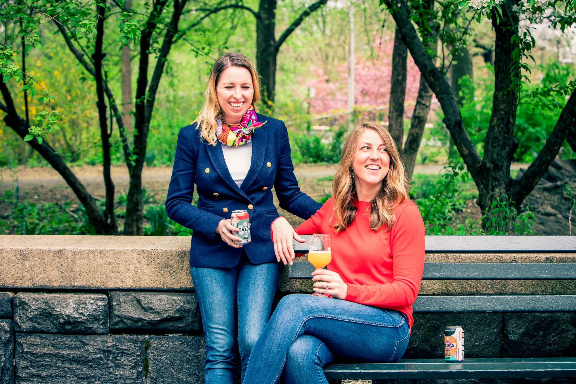 two women sitting on a park bench