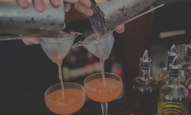 a hand holding a glass of wine