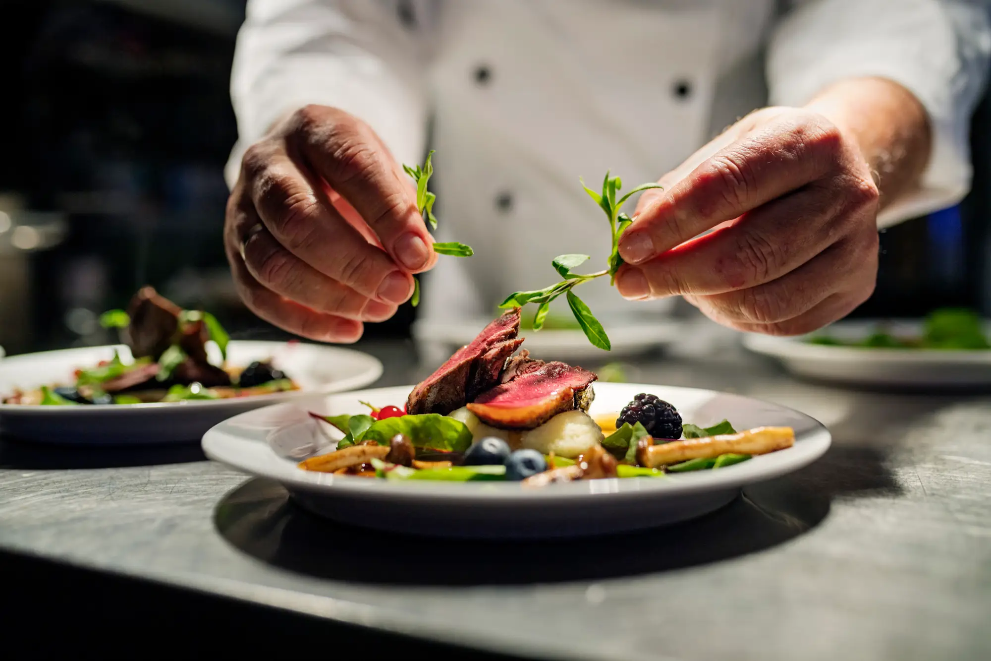 a person cutting food on a plate