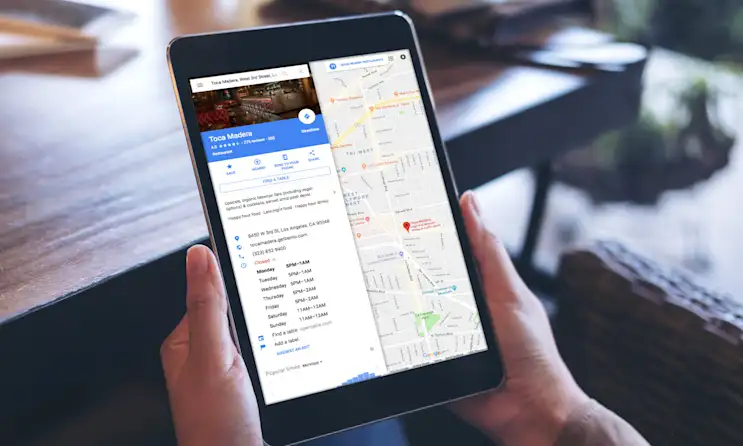 a hand holding a laptop