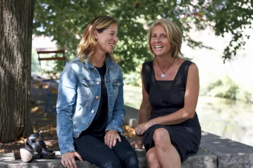 two women sitting on a bench