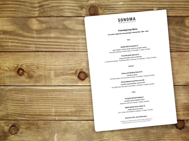 a wooden table with a restaurant menu on it.