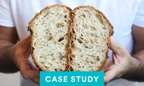 a hand holding a piece of bread