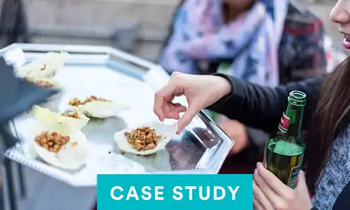a woman sitting at a table eating food