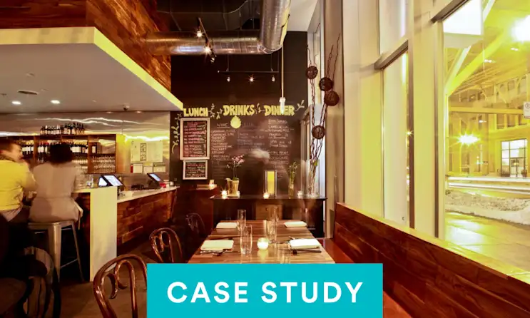 a group of people sitting at a table in a restaurant