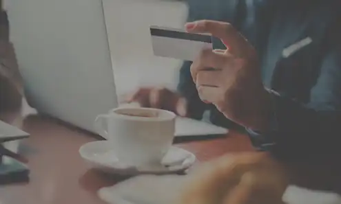 a person sitting at a table with a cup of coffee