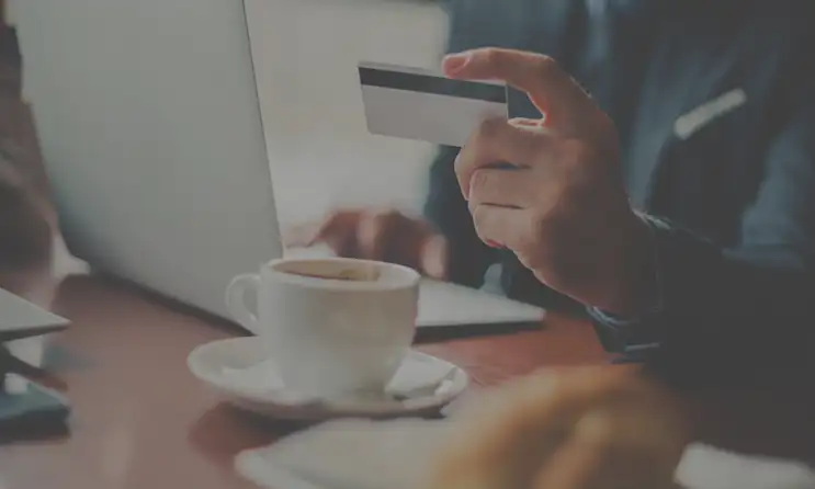 a person sitting at a table with a cup of coffee