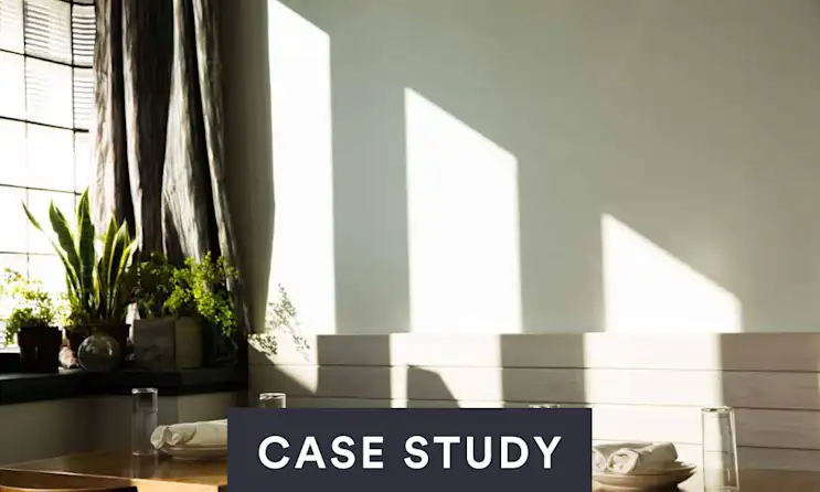 a room filled with furniture and vase of flowers on a table